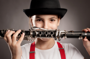 a girl holding a clarinet